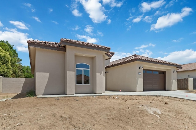 8440 Lake Shore Dr, Chowchilla, CA 93610 - view of front of house featuring a garage, stucco siding, a tile roof, and driveway