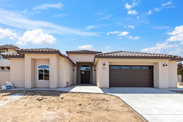 8385 Lake Shore Dr, Chowchilla, CA 93610 - mediterranean / spanish home with an attached garage, driveway, stucco siding, and a tiled roof