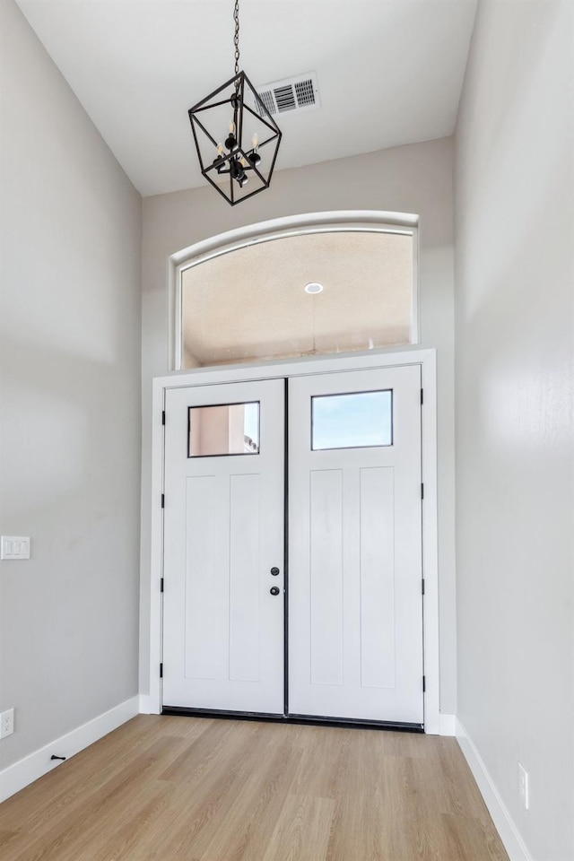 8385 Lake Shore Dr, Chowchilla, CA 93610 - entrance foyer featuring a chandelier, light wood-type flooring, and baseboards
