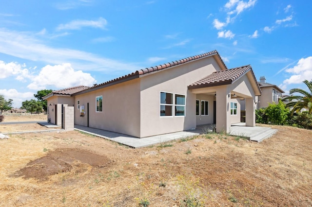 8385 Lake Shore Dr, Chowchilla, CA 93610 - back of house featuring a tiled roof, stucco siding, and a patio area