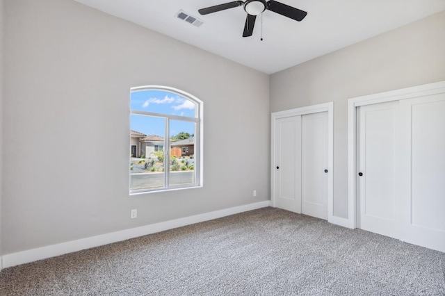 8385 Lake Shore Dr, Chowchilla, CA 93610 - unfurnished bedroom with carpet, multiple closets, baseboards, and a ceiling fan