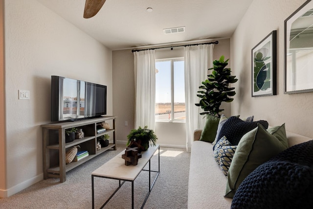 1151 Maclure Ave W, Madera, CA 93636 - carpeted living area with baseboards and ceiling fan