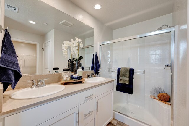 1151 Maclure Ave W, Madera, CA 93636 - bathroom with double vanity, a stall shower, a walk in closet, and recessed lighting