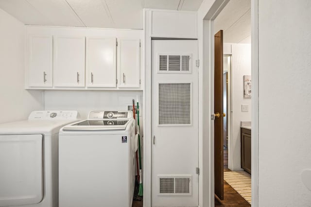 2627 W Midvalley, Visalia, CA 93277 - laundry room with washing machine and dryer, cabinet space, and wood finished floors