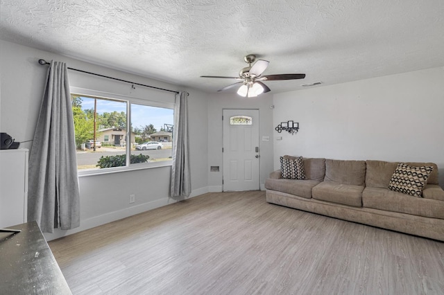 958 E Cornell Ave, Fresno, CA 93704 - living room featuring ceiling fan, light wood-type flooring, a textured ceiling, and baseboards