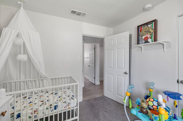 958 E Cornell Ave, Fresno, CA 93704 - bedroom with a nursery area, carpet floors, and a textured ceiling