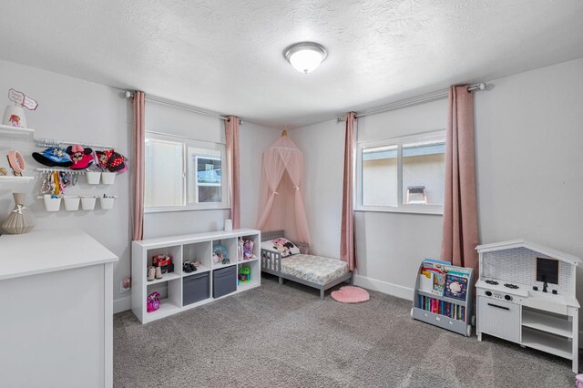 958 E Cornell Ave, Fresno, CA 93704 - recreation room with a textured ceiling, carpet flooring, and baseboards