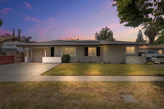 958 E Cornell Ave, Fresno, CA 93704 - single story home with concrete driveway, a garage, roof mounted solar panels, and stucco siding