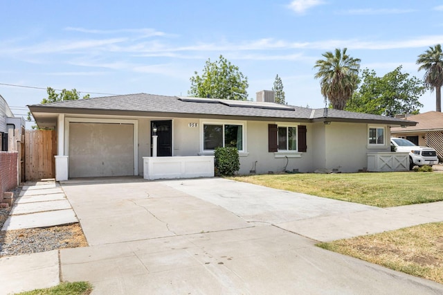 958 E Cornell Ave, Fresno, CA 93704 - single story home with stucco siding, a garage, driveway, roof mounted solar panels, and roof with shingles