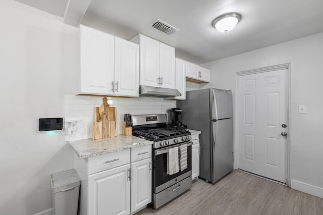 958 E Cornell Ave, Fresno, CA 93704 - kitchen with stainless steel appliances, under cabinet range hood, decorative backsplash, and white cabinets