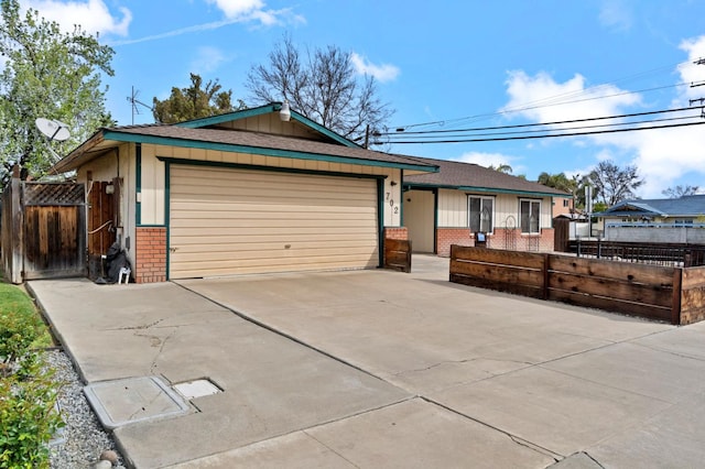 702 W Cortner Ave, Hanford, CA 93230 - ranch-style house with brick siding, an attached garage, and driveway