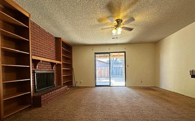 702 W Cortner Ave, Hanford, CA 93230 - unfurnished living room featuring a textured ceiling, carpet flooring, a ceiling fan, built in features, and a fireplace