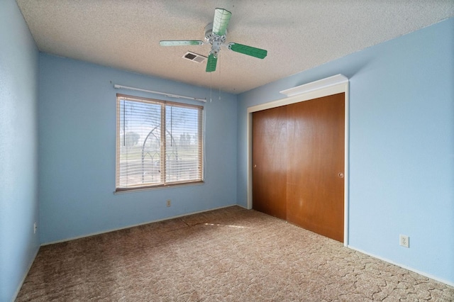 702 W Cortner Ave, Hanford, CA 93230 - unfurnished bedroom featuring a closet, carpet, a textured ceiling, and a ceiling fan