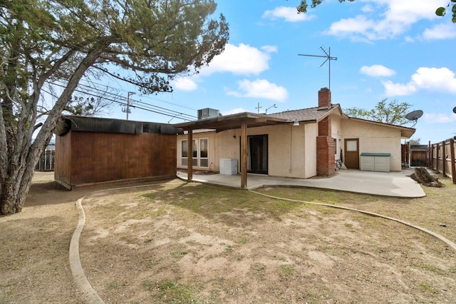 702 W Cortner Ave, Hanford, CA 93230 - rear view of property with a patio, a chimney, and stucco siding