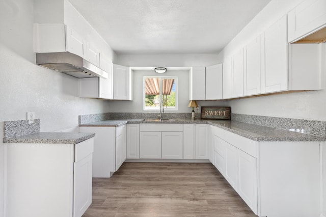 4641 E Weldon Ave, Fresno, CA 93703 - kitchen featuring a sink, light stone countertops, and white cabinets