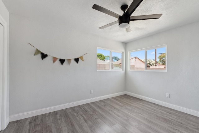 4641 E Weldon Ave, Fresno, CA 93703 - spare room featuring a textured ceiling, wood finished floors, ceiling fan, and baseboards