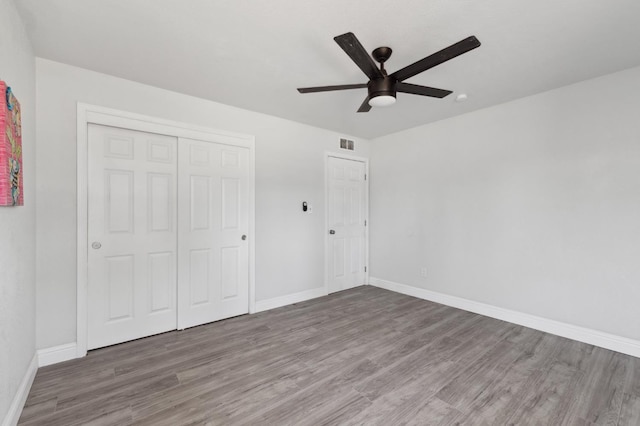 4641 E Weldon Ave, Fresno, CA 93703 - unfurnished bedroom with wood finished floors, baseboards, a closet, and ceiling fan