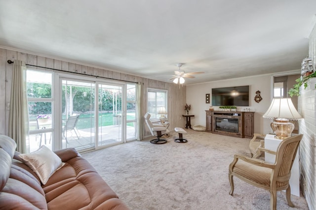 3979 N Pleasant Ave, Fresno, CA 93705 - living area with carpet, ornamental molding, ceiling fan, and a glass covered fireplace