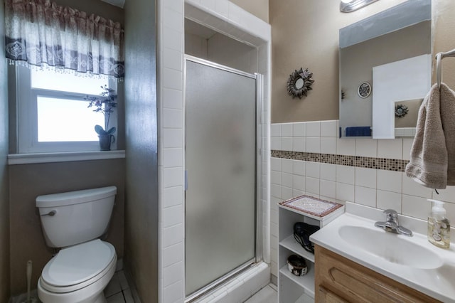 3979 N Pleasant Ave, Fresno, CA 93705 - full bathroom featuring a shower stall, toilet, tile walls, vanity, and tile patterned floors