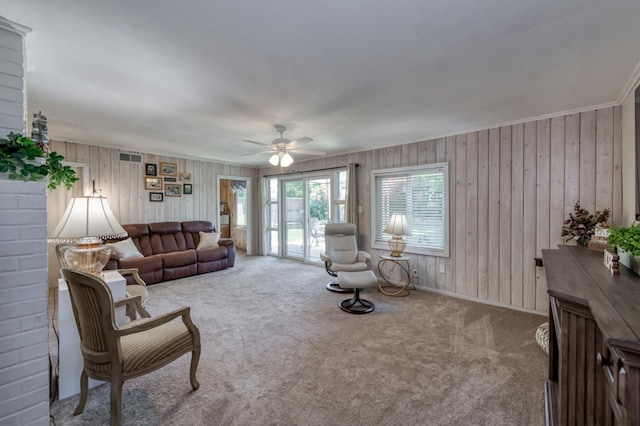 3979 N Pleasant Ave, Fresno, CA 93705 - carpeted living area featuring ceiling fan, wooden walls, and baseboards