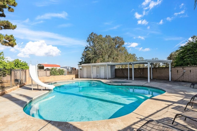 4341 W Dakota Ave, Fresno, CA 93722 - view of pool with a water slide, a fenced backyard, and a patio