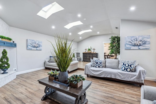 4341 W Dakota Ave, Fresno, CA 93722 - living room featuring a skylight, vaulted ceiling, recessed lighting, wood finished floors, and baseboards