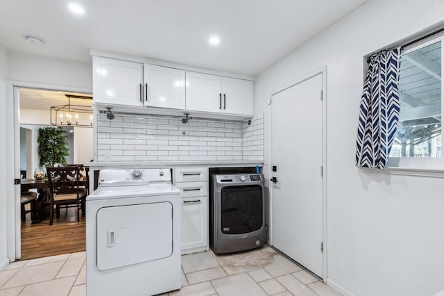 4341 W Dakota Ave, Fresno, CA 93722 - laundry room with washing machine and dryer, cabinet space, a chandelier, recessed lighting, and light tile patterned flooring