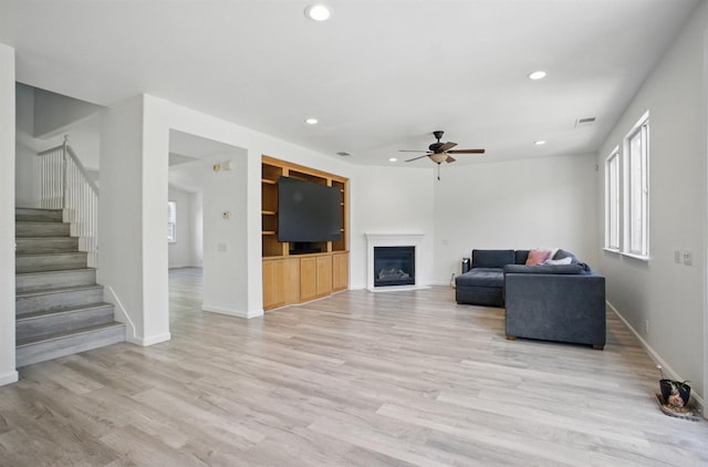 1216 Avignon Dr, Merced, CA 95348 - living area featuring a ceiling fan, recessed lighting, stairway, light wood finished floors, and baseboards