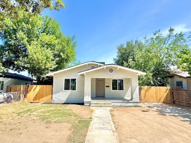 4221 E Grant Ave, Fresno, CA 93702 - bungalow-style home with stucco siding, covered porch, and a gate