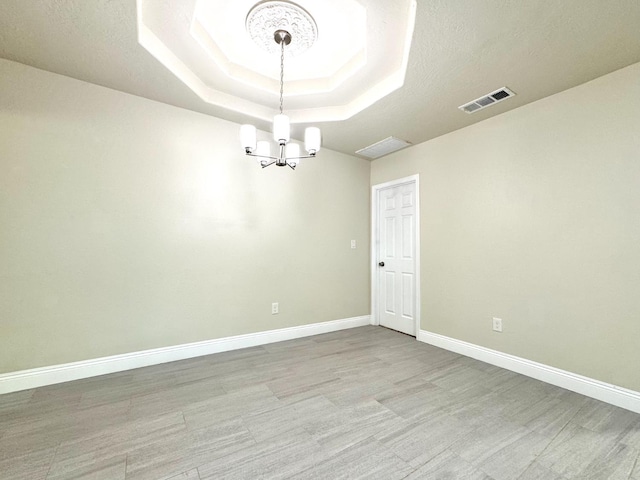 4221 E Grant Ave, Fresno, CA 93702 - empty room with a chandelier, a raised ceiling, and baseboards