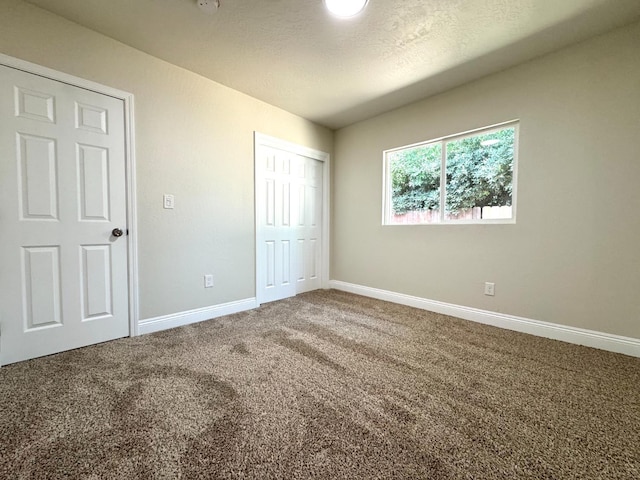 4221 E Grant Ave, Fresno, CA 93702 - unfurnished bedroom with carpet, baseboards, a closet, and a textured ceiling