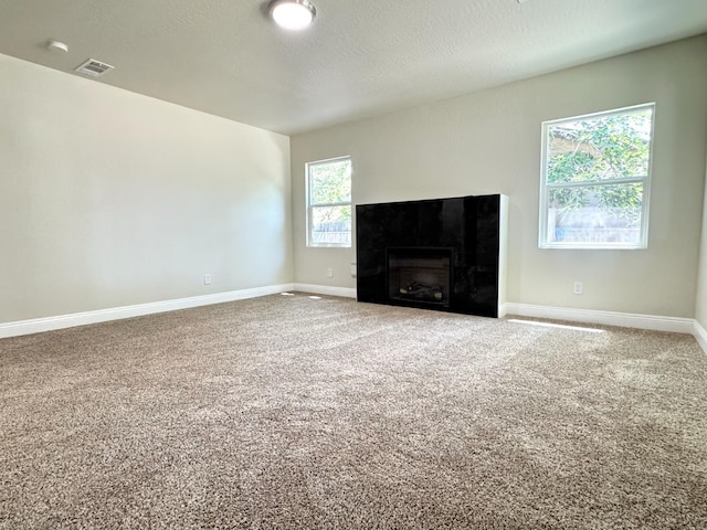 4221 E Grant Ave, Fresno, CA 93702 - unfurnished living room with carpet floors, baseboards, and a fireplace