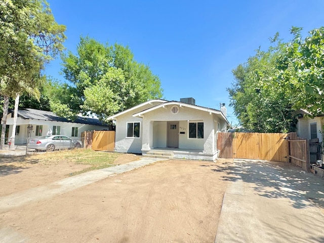 4221 E Grant Ave, Fresno, CA 93702 - bungalow-style house featuring a gate, stucco siding, a chimney, and driveway