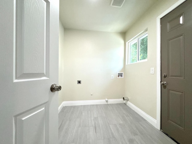 4221 E Grant Ave, Fresno, CA 93702 - laundry area with hookup for an electric dryer, hookup for a washing machine, baseboards, gas dryer hookup, and light wood-style floors
