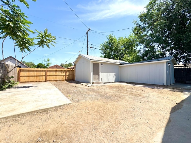 4221 E Grant Ave, Fresno, CA 93702 - rear view of house with a fenced backyard and a patio
