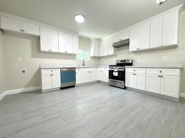 4221 E Grant Ave, Fresno, CA 93702 - kitchen with gas stove, dishwashing machine, under cabinet range hood, and baseboards