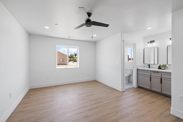 25900 Tanforan Dr, Madera, CA 93638 - unfurnished bedroom featuring ensuite bathroom, light wood-style flooring, recessed lighting, and baseboards