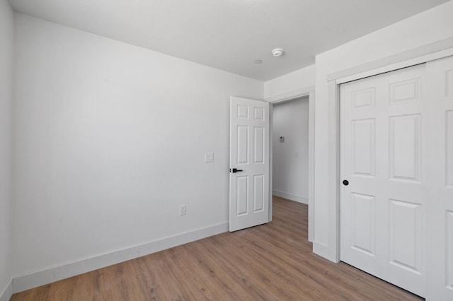 25900 Tanforan Dr, Madera, CA 93638 - unfurnished bedroom featuring baseboards, wood finished floors, and a closet