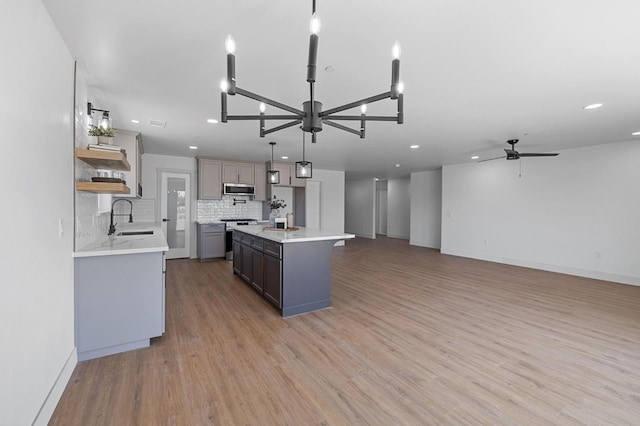 25900 Tanforan Dr, Madera, CA 93638 - kitchen featuring appliances with stainless steel finishes, a sink, light countertops, recessed lighting, and backsplash