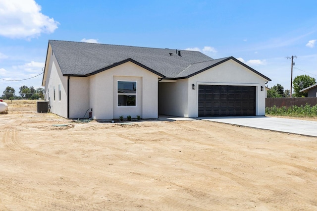25900 Tanforan Dr, Madera, CA 93638 - modern farmhouse featuring a garage, driveway, central AC, a shingled roof, and stucco siding