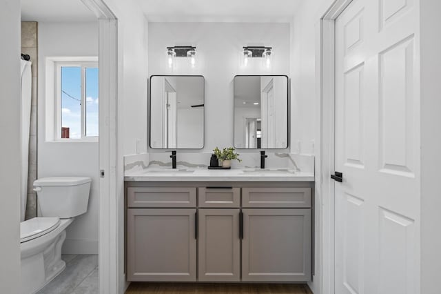 25900 Tanforan Dr, Madera, CA 93638 - full bath with double vanity, toilet, baseboards, and a shower