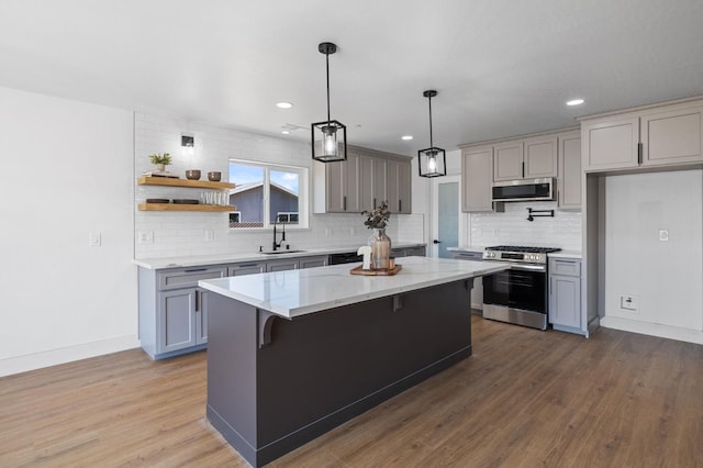 25900 Tanforan Dr, Madera, CA 93638 - kitchen featuring appliances with stainless steel finishes, gray cabinetry, a sink, tasteful backsplash, and recessed lighting