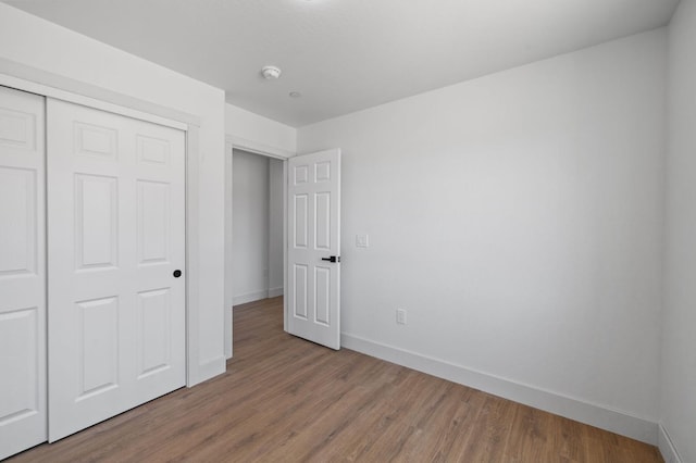 25900 Tanforan Dr, Madera, CA 93638 - unfurnished bedroom with baseboards, wood finished floors, and a closet