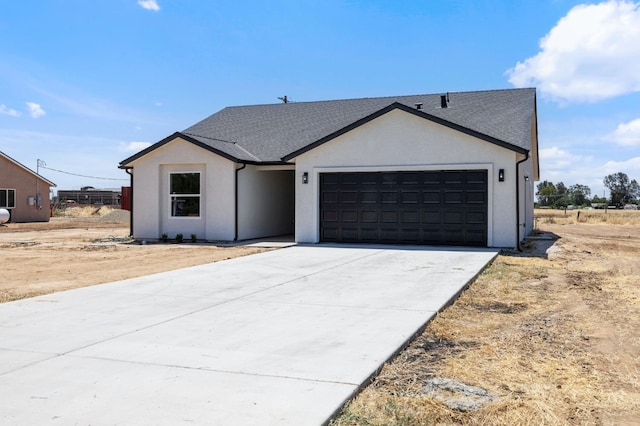 25900 Tanforan Dr, Madera, CA 93638 - view of front of home featuring an attached garage, driveway, and stucco siding