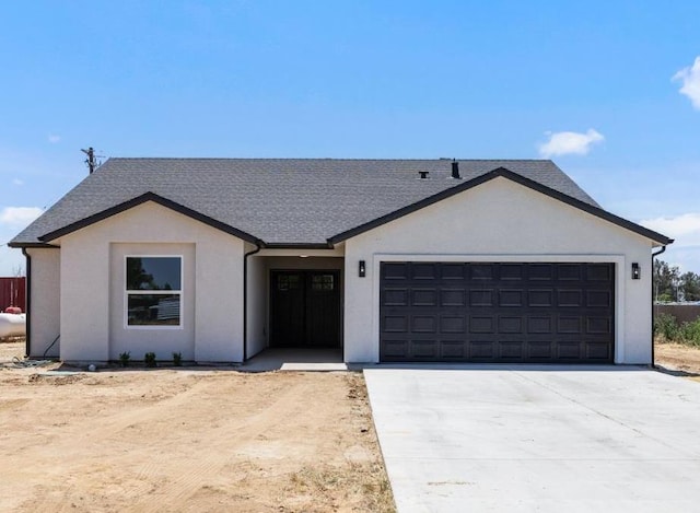 25900 Tanforan Dr, Madera, CA 93638 - view of front of home with an attached garage, driveway, stucco siding, and a shingled roof