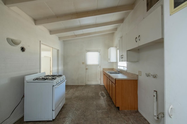 2108 E Sussex Way, Fresno, CA 93726 - kitchen featuring white range with gas stovetop, a sink, white cabinetry, baseboards, and light countertops