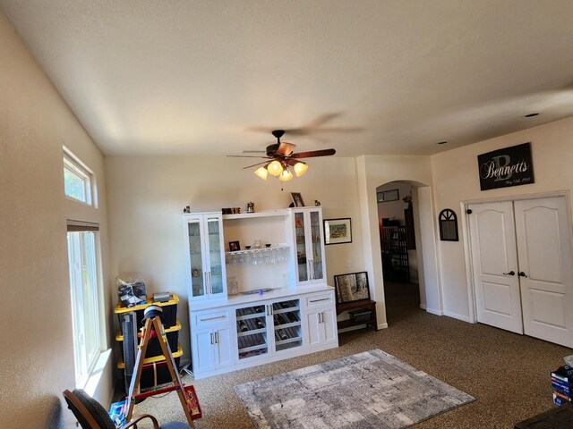 2513 Twain Ave, Clovis, CA 93611 - carpeted living area with arched walkways, ceiling fan, and baseboards