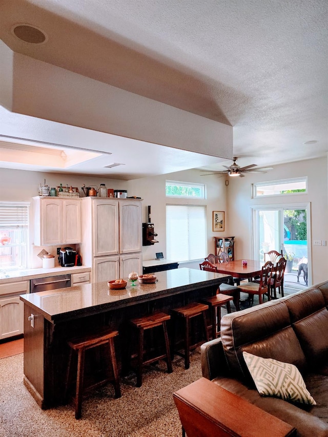 2513 Twain Ave, Clovis, CA 93611 - kitchen with a breakfast bar, dishwasher, healthy amount of natural light, a textured ceiling, and a ceiling fan