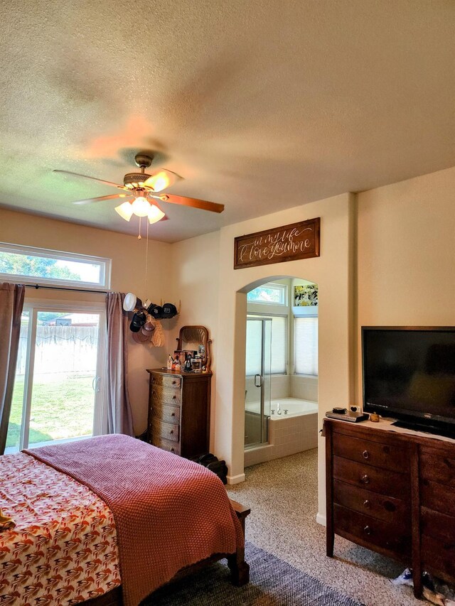 2513 Twain Ave, Clovis, CA 93611 - carpeted bedroom with arched walkways, a textured ceiling, baseboards, a ceiling fan, and ensuite bathroom