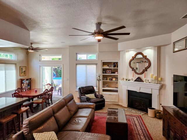 2513 Twain Ave, Clovis, CA 93611 - living room featuring a ceiling fan, a fireplace, and a textured ceiling
